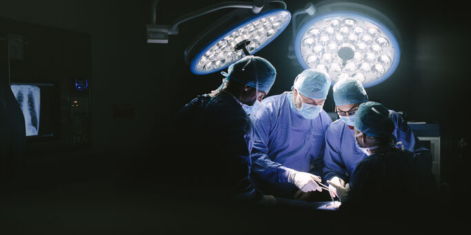 Medical team performing surgery. Group of surgeons in hospital operation theater.