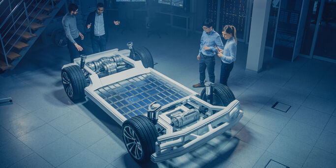 Team of Automotive Engineers Working on Electric Car Chassis Platform