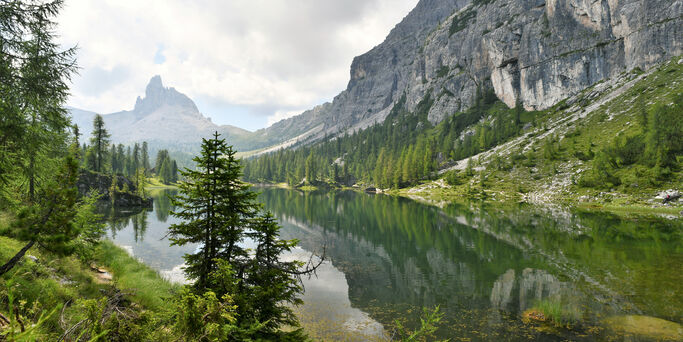 Day light view of alpine lake with reflection in the water